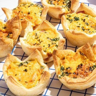 Cheesy mini-quiches on blue and white striped plate
