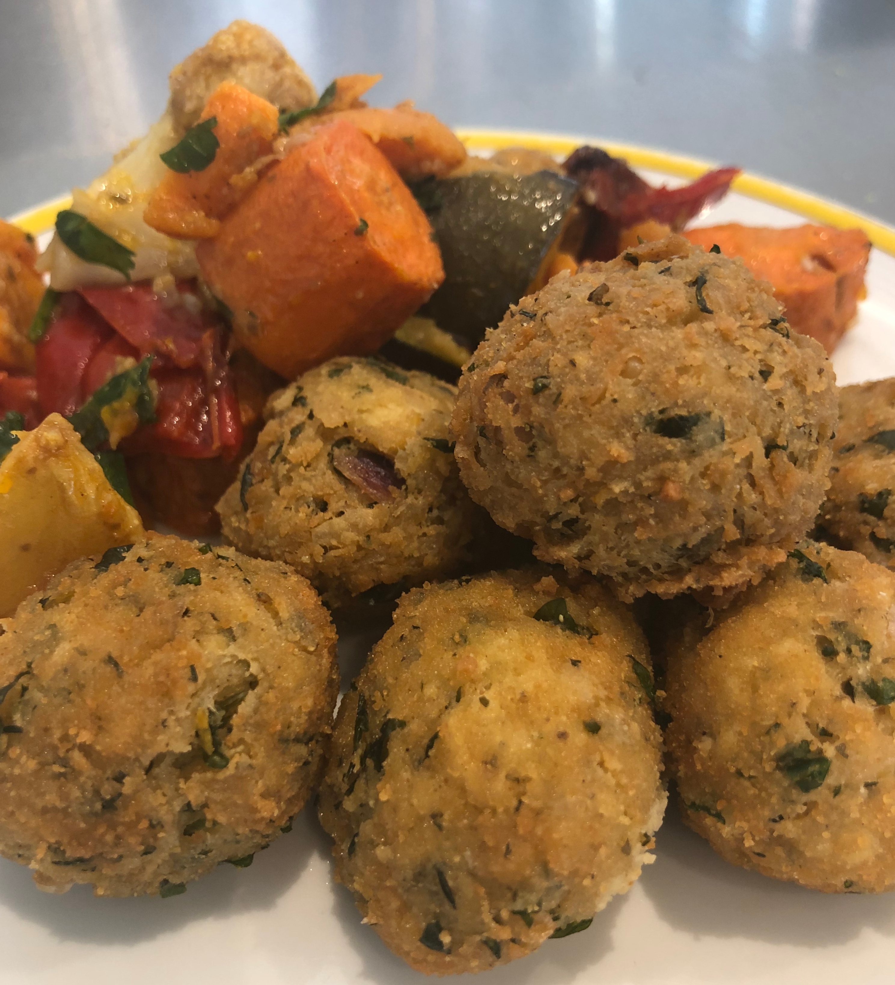 Arancini balls with roast veggies on a plate