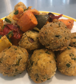 Load image into Gallery viewer, Arancini balls with roast veggies on a plate
