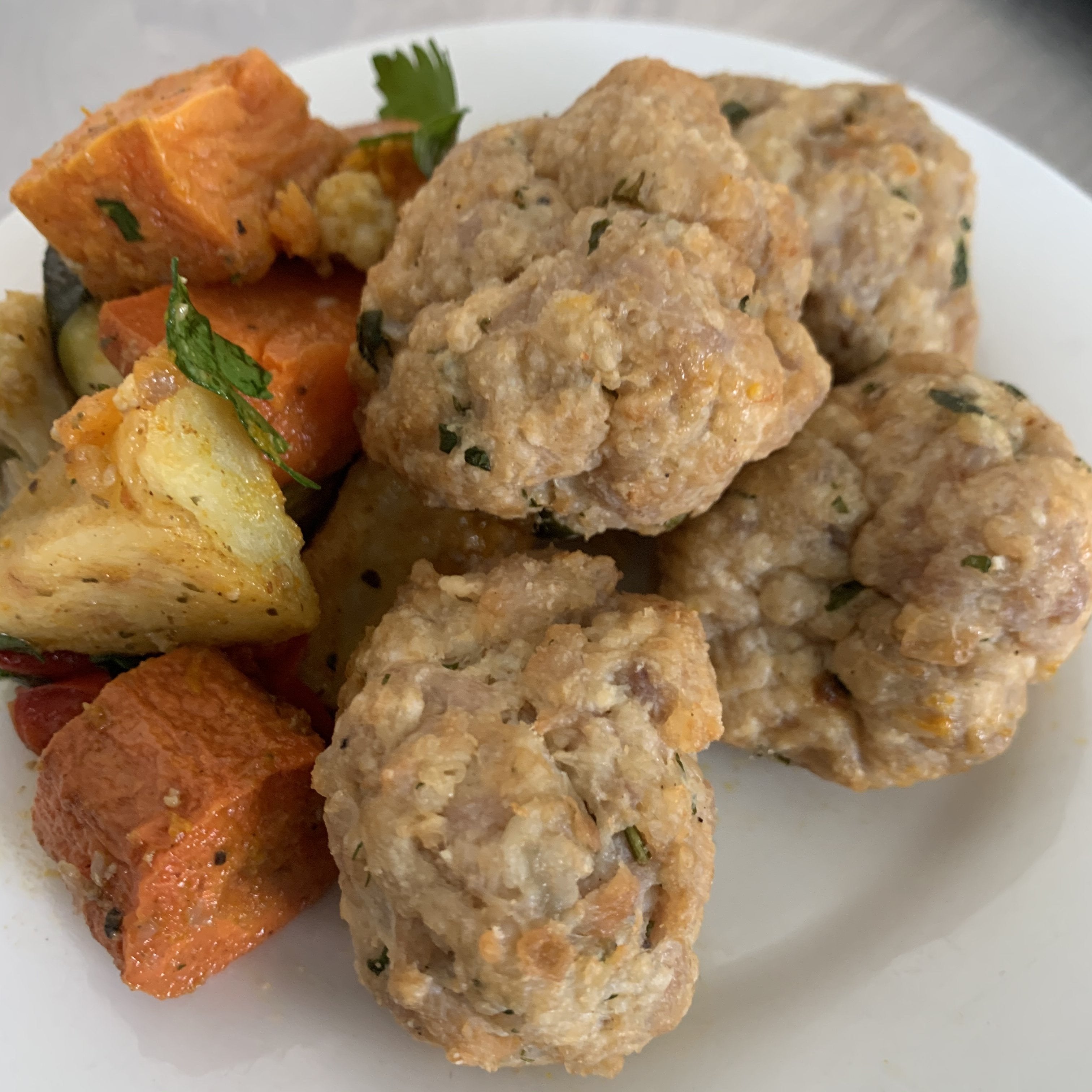 chicken polpette on a plate with vegetables