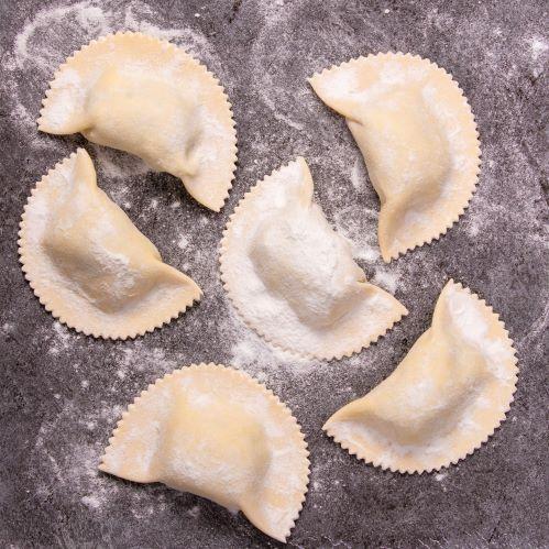 Jumbo agnolotti pieces on floured bench
