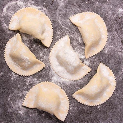 Jumbo agnolotti pieces on floured bench